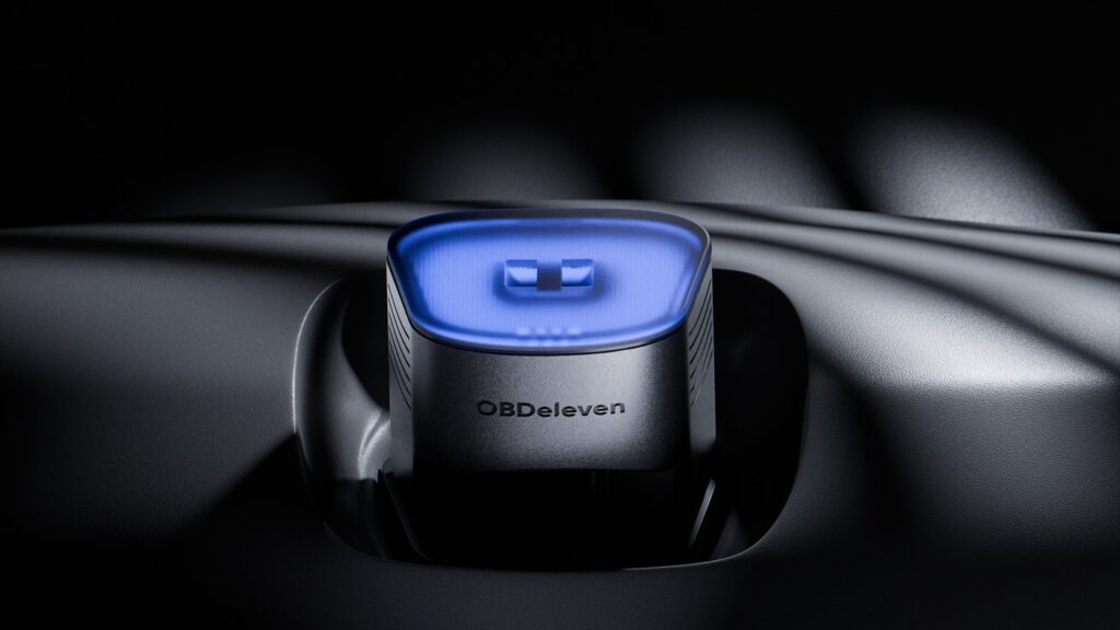 The OBDeleven 3 device glowing blue on a car dashboard